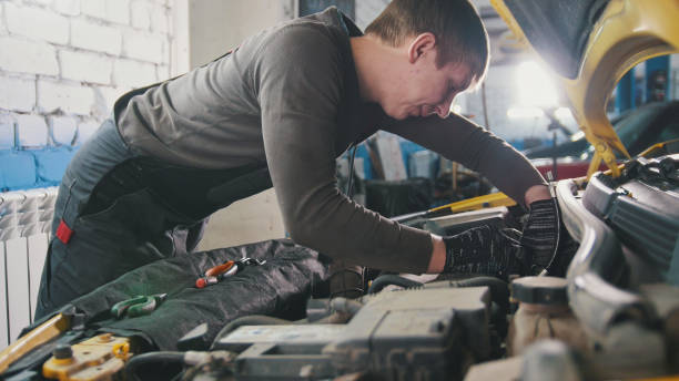 istock Mechanic in car repairing service - diagnostics in engine compartment 898235538