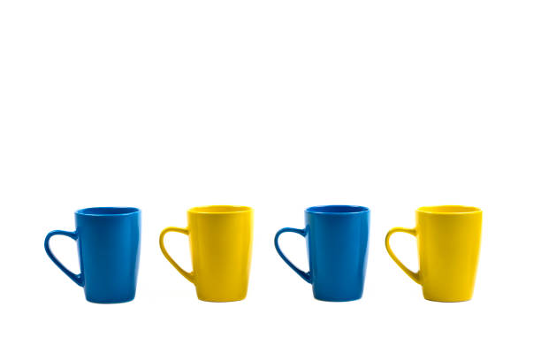 istock Four cups in a row in front of a white background 898241424