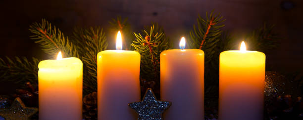 istock Four burning advent candles and luminous lights 898241504