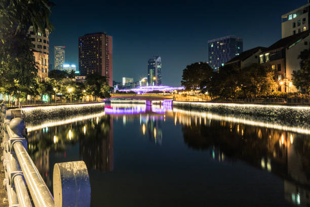 istock Modern brightly illuminated bridge on the Singapore river at night - 1 898241608