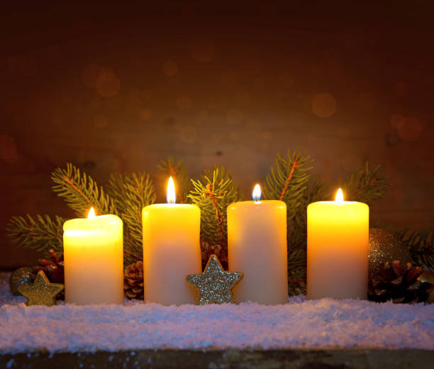 istock Four burning advent candles and luminous lights 898241920