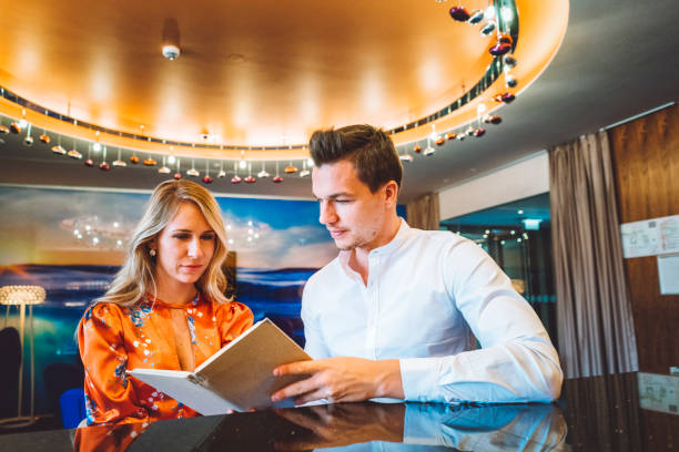istock Hungry couple picking out their wedding menu 898244136