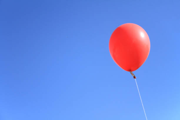 istock red balloon under the blue sky 898244494