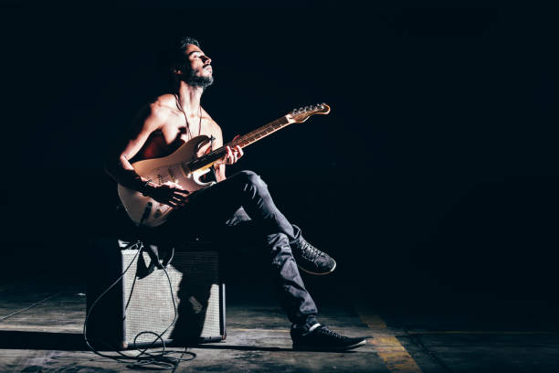 istock Young Afro American man playing electric guitar 898245930