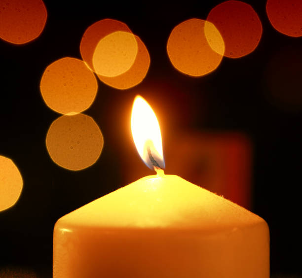 istock Single candle defocused spots at christmas 898246588