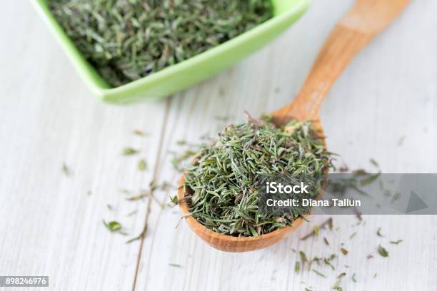 Dried Thyme On Wooden Surface Stock Photo - Download Image Now - Thyme, Dried Food, Chopped Food