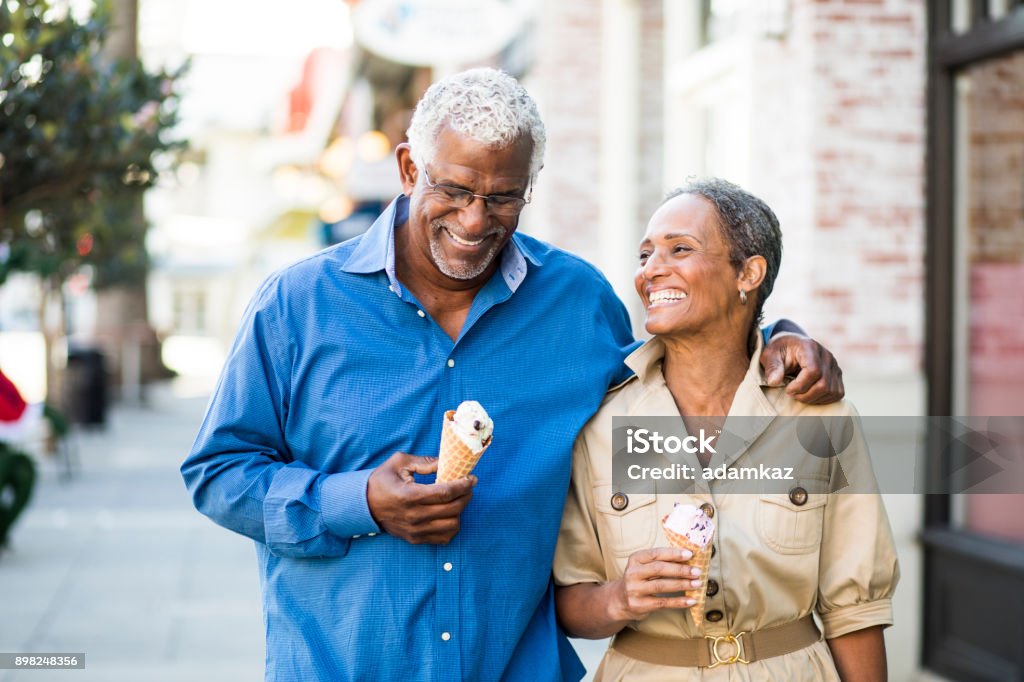 African American Senior Couple On the Town with Ice Cream A senior african american couple enjoy an evening on the town with ice cream Senior Adult Stock Photo