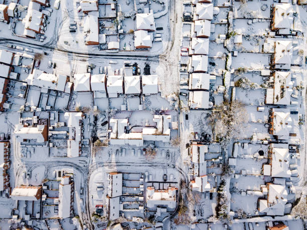 Aerial view of snowed in traditional housing suburbs in England. stock photo