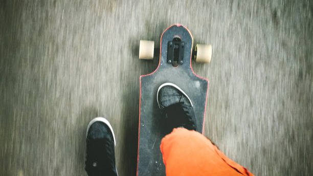 istock Longboarder driving on the street 898254098