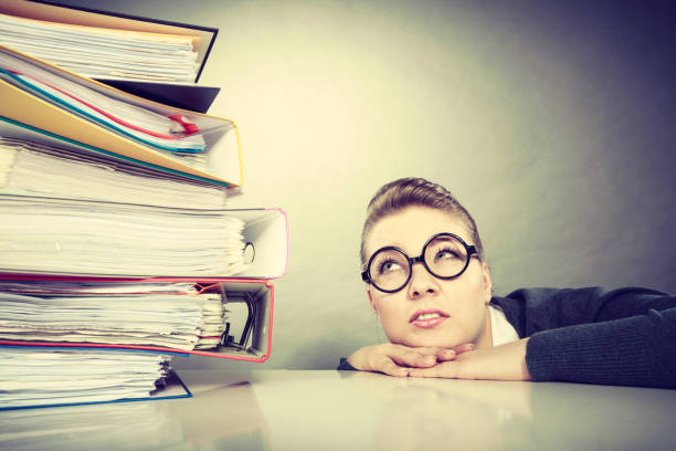 istock Accountant terrified of pils of binders. 898255008