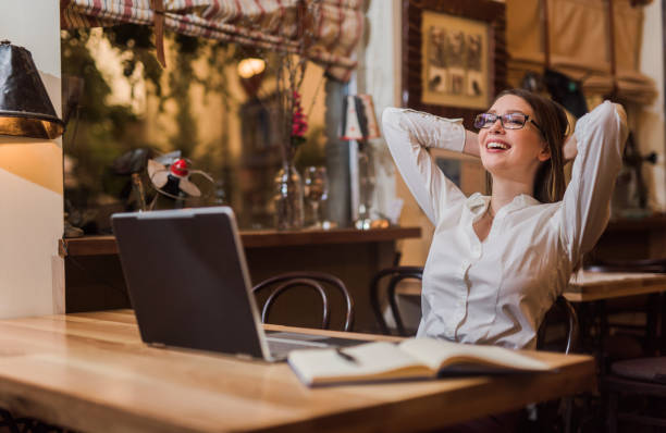 Young woman feeling relieved after late night work is done. Young woman feeling relieved after late night work is done. relief emotion stock pictures, royalty-free photos & images