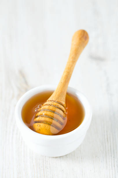 istock honey on wooden surface 898256652