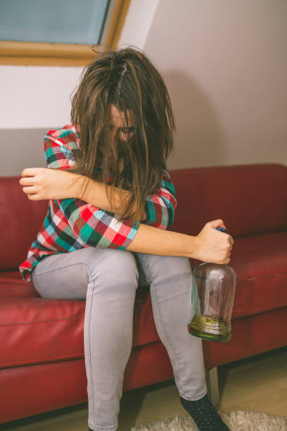 istock Young drunk woman sitting in the sofa 898257592