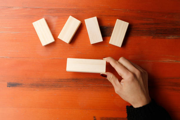 istock A woman showing a wooden block 898258090