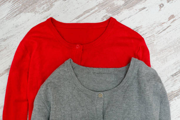 istock Two sweaters on a wooden background. Fashionable concept 898259138