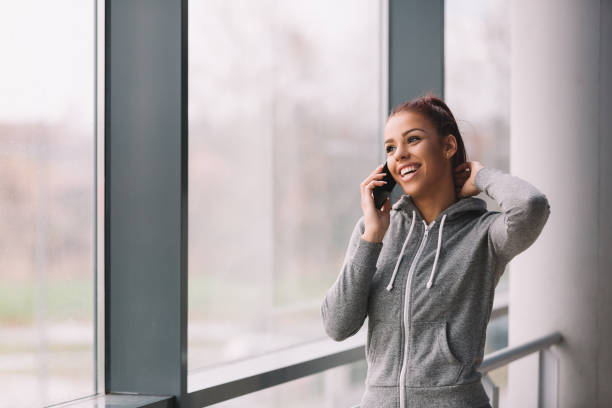 istock Fit girl talking on phone before workout. 898260224