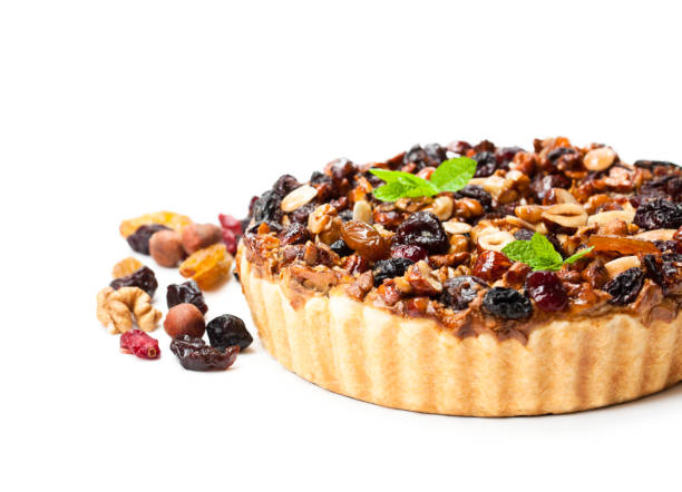 istock Delicious  tart with dried berries and nuts isolated on white 898260494