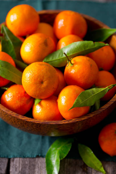 istock mandarins in a wooden bowl 898260610