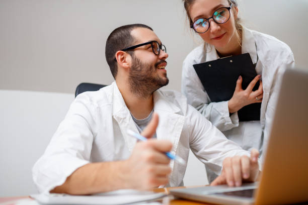 istock Male and female scientist using laptop at the laboratory 898262170