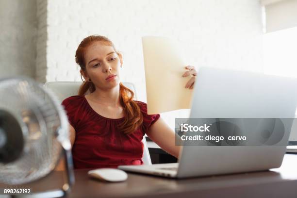 Businesswoman Sweating At Work With Broken Conditioner Stock Photo - Download Image Now