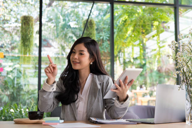 istock businesswoman using tablet computer at workplace. startup woman working with business plan report document at office.  young female entrepreneur analyze accounting market data.  financial adviser with paperwork on table. 898262824