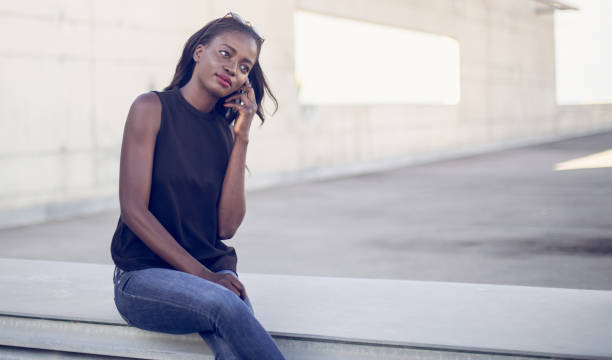 istock Black girl talks on mobile 898264260