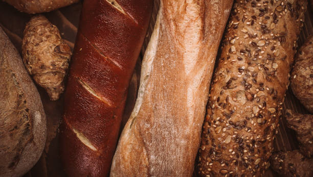 istock Many mixed baked breads and rolls on rustic wooden table 898265438