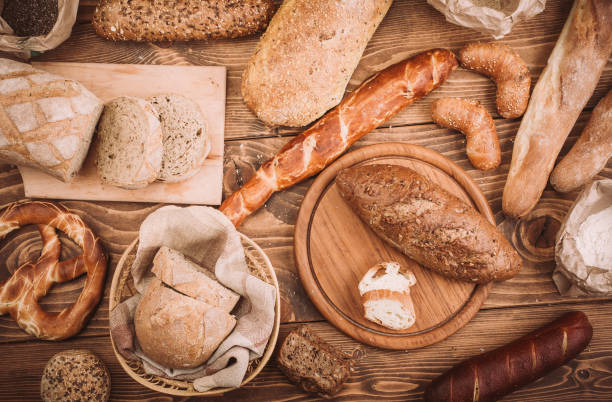 istock Many mixed baked breads and rolls on rustic wooden table 898265916