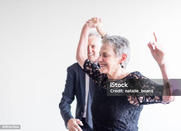 Elegantly Dressed Couple Dancing Exuberantly Stock Photo - Download Image Now - Dancing, Senior Adult, Senior Couple