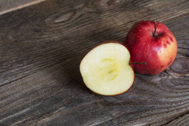 istock Cut red apple on a wooden background 898272988