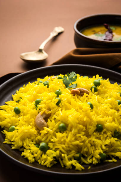 istock Basmati Rice Pilaf or pulav with Peas, or vegetable rice using green peas also known as matar pulav, with added yellow colour, served with plain dal 898274496