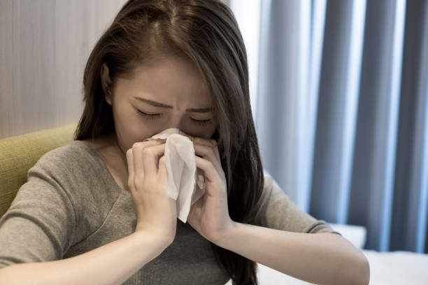 istock woman sick and sneezing 898280176