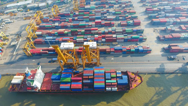 istock Logistics and transportation of Container Cargo ship and Cargo working crane bridge in shipyard 898280398