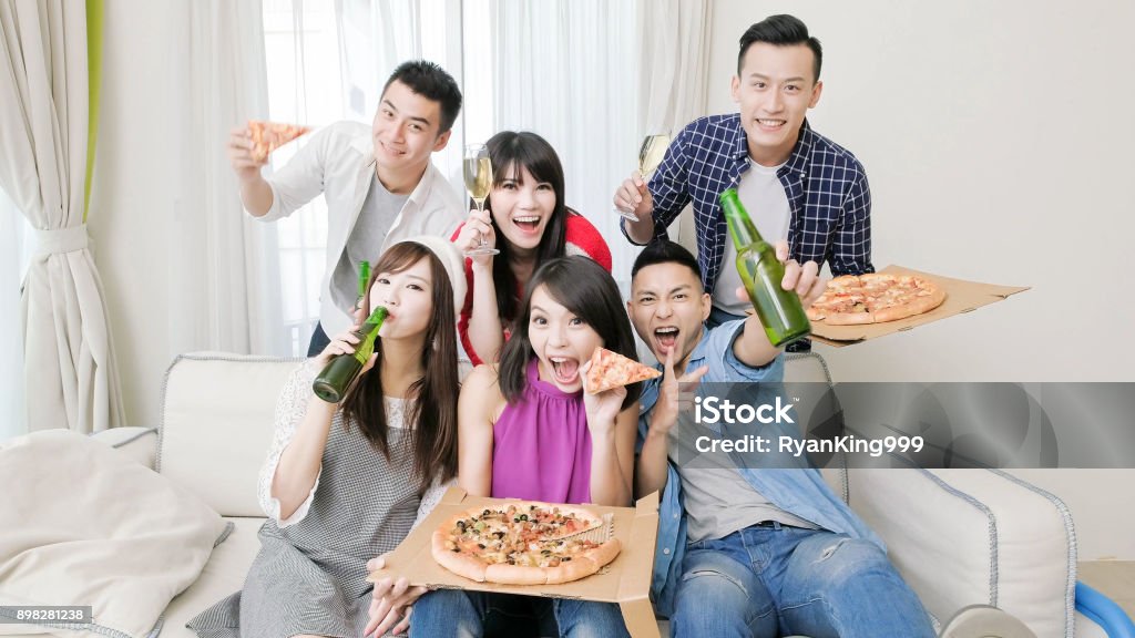 young people party young people eat pizza and drink beer with party Adult Stock Photo