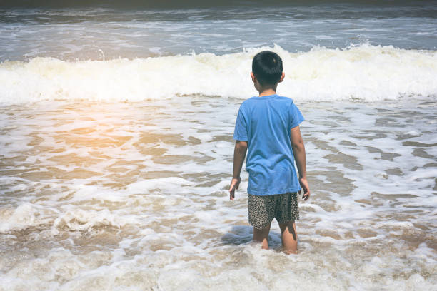 istock Little boy playing on the beach 898286120