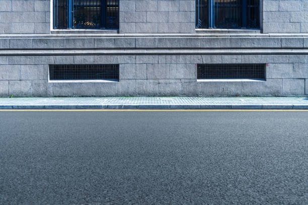 istock empty asphalt road front of the wall 898288054