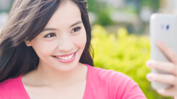 istock woman selfie in park 898296072