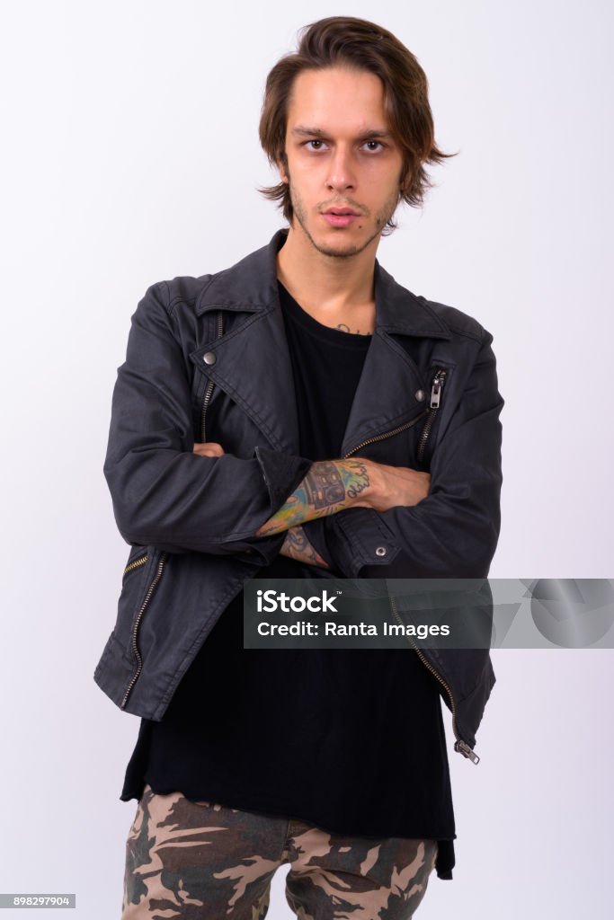 Studio shot of rebellious young man against white background Portrait of rebellious young man against white background 20-24 Years Stock Photo