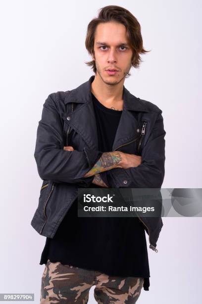 Studio Shot Of Rebellious Young Man Against White Background Stock Photo - Download Image Now
