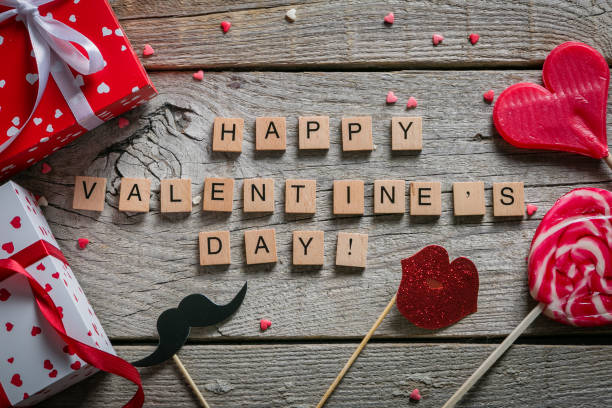istock Valentine's day concept - presents, candy, glasses on rustic wood background 898299414