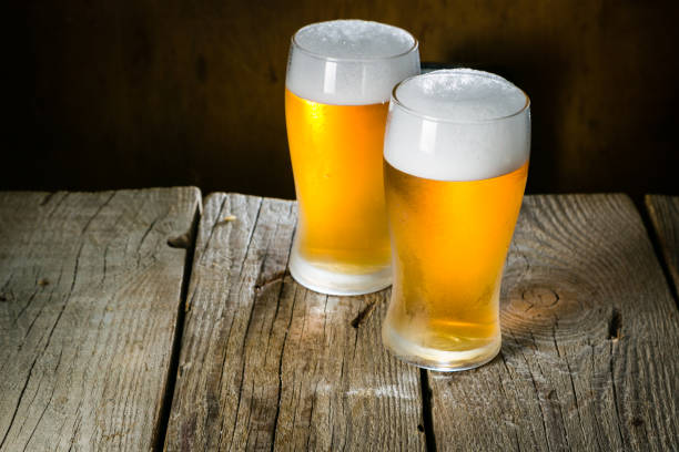 istock Beer in frosty mugs on rustic background 898301232