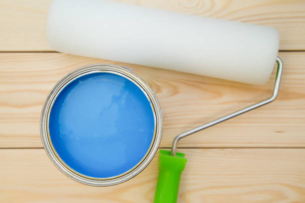 istock A can of blue paint and a paint roller 898305876