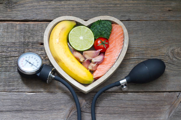 Health heart diet food concept with blood pressure gauge Health heart diet food concept with blood pressure gauge closeup fish blood stock pictures, royalty-free photos & images