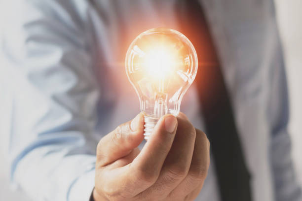 istock businessman hand holding light bulb. idea concept with innovation and inspiration 898307538
