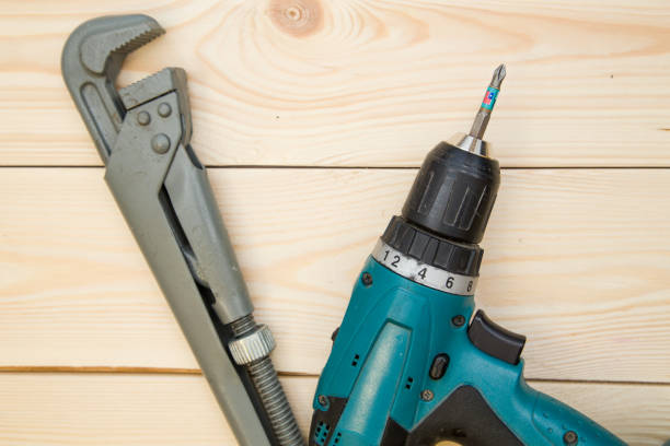 istock A screw gun and pilers on a wooden background 898307692