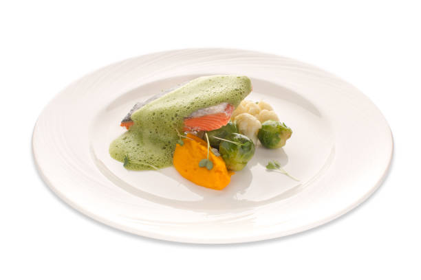 istock Red fish and vegetables under a frothy sauce on an isolated background 898310592