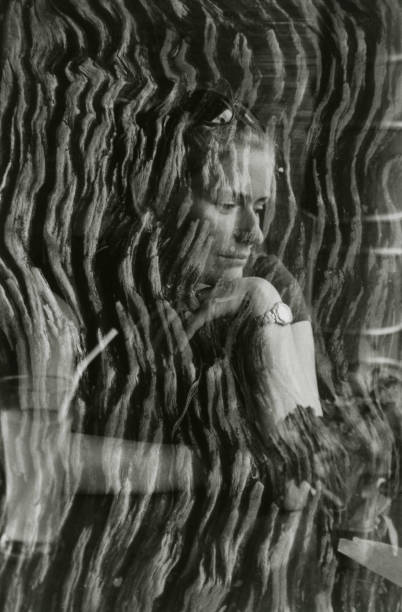 istock Pensive girl with cocktail and tree bark. 898312582