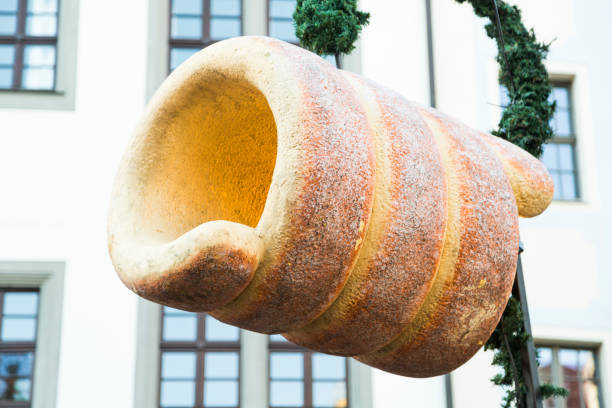 Christmas big plastic traditional yellow decorative delicious czech artificial trdelnik hanging outdoor on shop roof on fair market