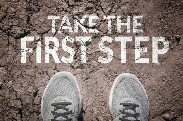 Take the first step Take the first step text and sneakers on dry land top view sports shoe photos stock pictures, royalty-free photos & images