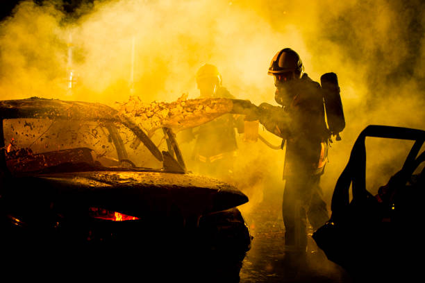 istock Firefighters spraying water on burning car 898314610